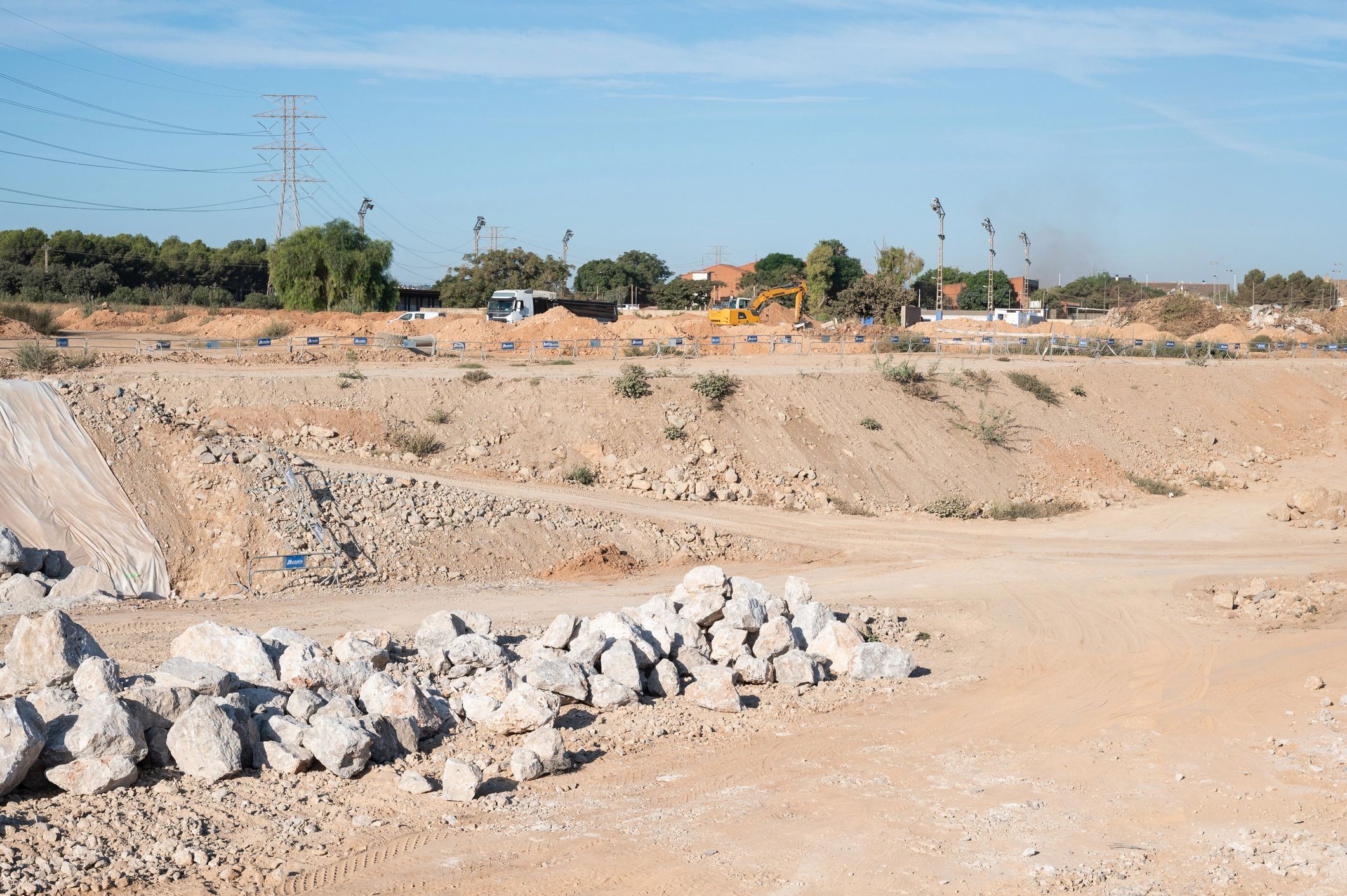 Excavator and truck working on a large earthworks site