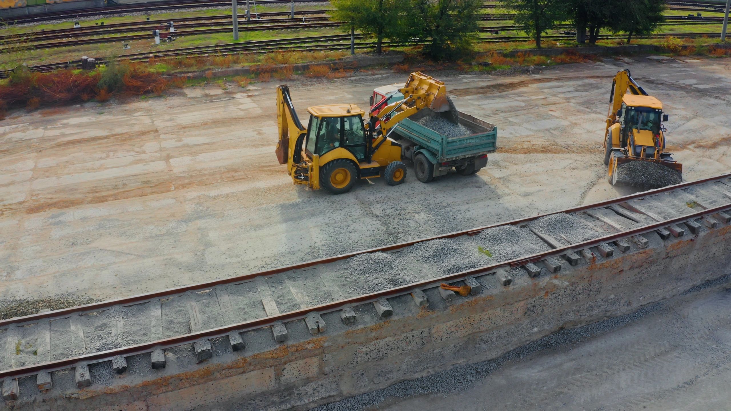 Front loader loading aggregate into a dump truck for site operations