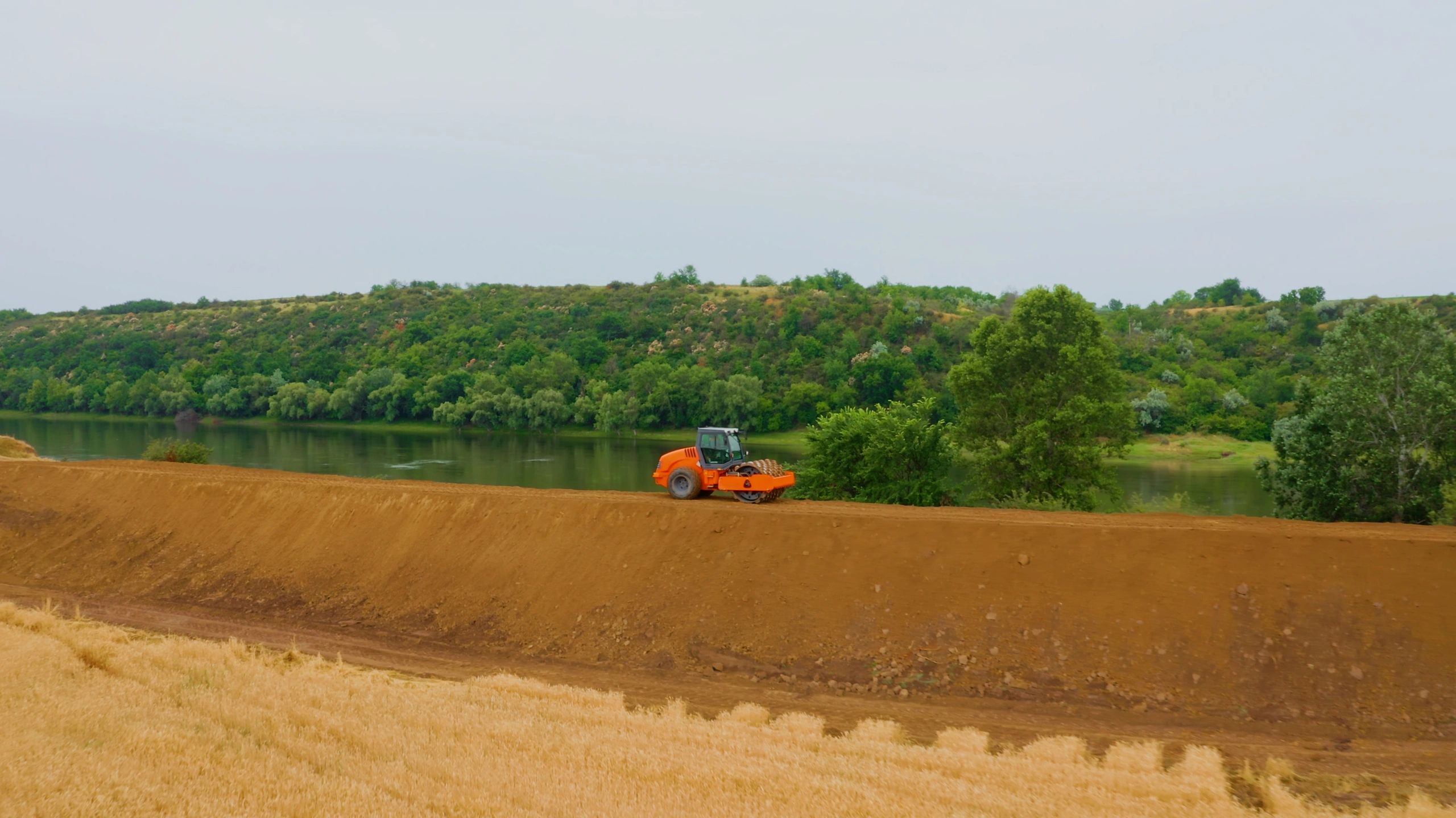 Compaction equipment working on an embankment for a new infrastructure project